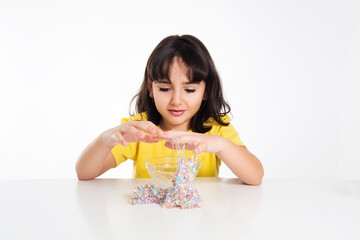girl in yellow with slime on white background.