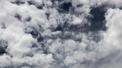 Obraz premium black and white storm clouds background. Light in the Dark and Dramatic Storm Clouds background, Dark clouds before a thunder-storm.