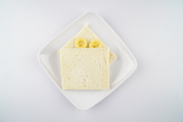 Delicious Ripe yellow bananas fruits with white bread isolated on white background, Banana toping on white bread