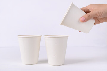 Biodegradable coffee cup made from natural fiber with hand on white background, Eco friendly and...