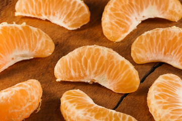 Satsuma Mandarin Tangerine Fruit Wedges On Natural Wood (Citrus unshiu)