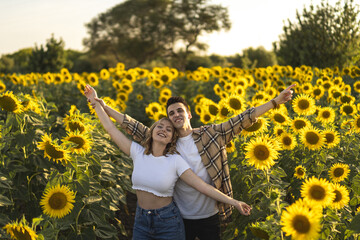 Closeup shot of a Caucasian lovely couple at the sunflowers field in Spain © Miguel Angel Junquera/Wirestock