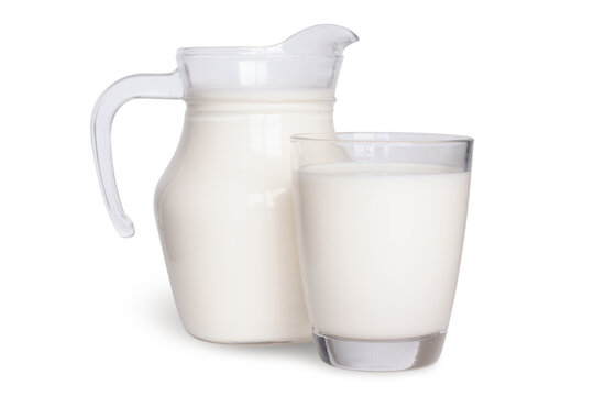 Natural whole milk in a jug and a glass isolated on a white background.