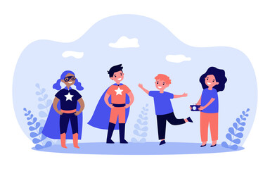Boy taking picture with children in superhero costumes. Girl holding camera to take photo flat vector illustration. Photography, entertainment concept for banner, website design or landing web page