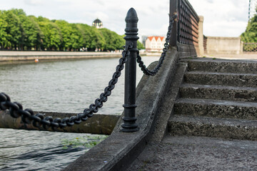 An old chain fence along a stone-paved road.