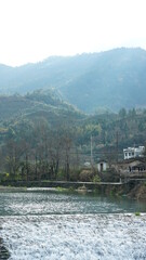 Fototapeta premium The beautiful countryside view with the river and mountains in the south of the China