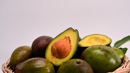 Whole and half avocado isolated on white background. Healthy food concept.