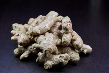 closeup heap of ginger root isolated on black background	
