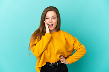 Teenager girl over isolated blue background with surprise and shocked facial expression