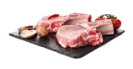 Slate plate with slices of raw pork ribs and vegetables on white background