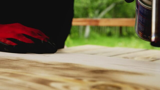 Firing wood with a gas burner for finishing. Firing technology, close-up, industrial