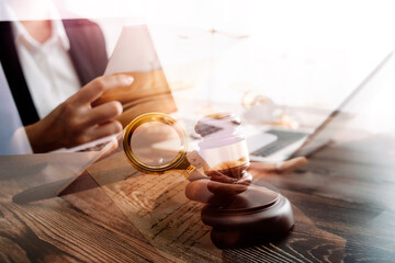 justice and law concept.Male judge in a courtroom on wooden table and Counselor or Male lawyer working in office. Legal law, advice and justice concept.