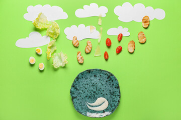 Creative composition with plate and ingredients for preparing tasty Caesar salad on color background