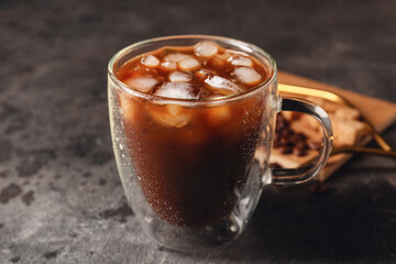 Cup of tasty iced coffee on grunge background