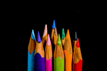 Sharp color pencil close up front view with dark background. Shallow depth of field shot