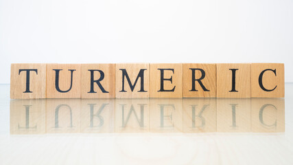 The word turmeric was created from wooden letter cubes. Gastronomy and spices.