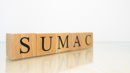 The word sumac was created from wooden letter cubes. Gastronomy and spices.