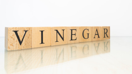The word Vinegar was created from wooden letter cubes. Gastronomy and spices.