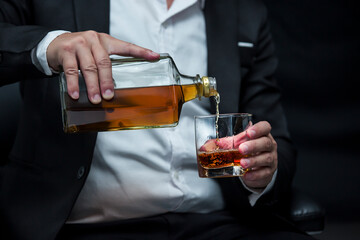Closeup businessmen holding a glass of whiskey