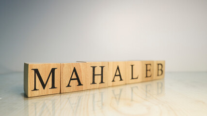 The word Mahaleb was created from wooden letter cubes. Gastronomy and spices.