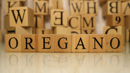 The word Oregano was created from wooden letter cubes. Gastronomy and spices.