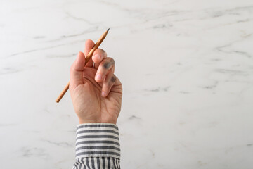 Dirty left hand in grey shirt after writing. Left hander day concept.