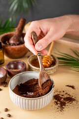  The process of making a homemade coffee scrub for skin care. Eco-friendly cosmetics, vertical photo