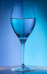 Studio shot of a glass of water with blue background