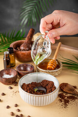  The process of making a homemade coffee scrub for skin care, adding oil. Eco-friendly cosmetics,...
