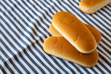 Whole Grain Hot Dog Buns on cloth, side view. Space for text.