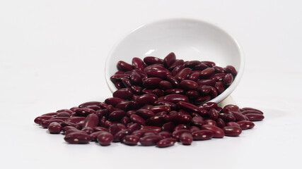 Kidney beans or Red beans spilled out of a bowl.