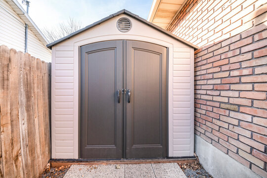 Vinyl outdoor shed with with walls and gray double door