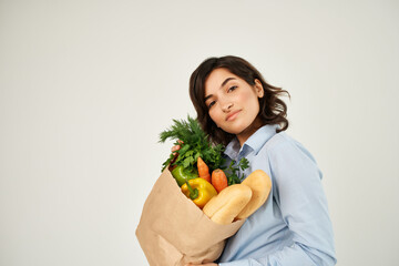 brunette with a package of groceries healthy food vegetables supermarket