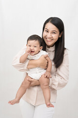 Mom holding baby girl and laughing very happy on white background