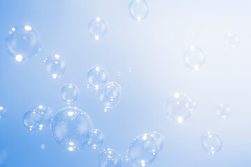 Beautiful Transparent Soap Bubbles Floating on Blue Background.
