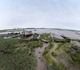 An abandoned boat decaying on the mud banks