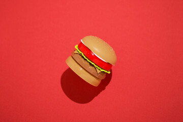 Burger junk food fast food unhealthy trans fat red background
