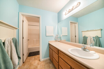 Fototapeta na wymiar Bathroom interior with sky blue wall with a room for a bathtub