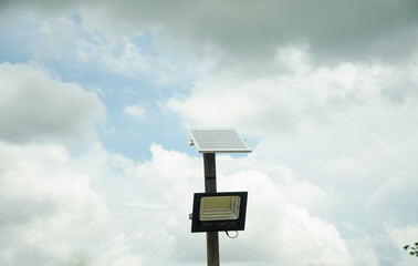 Street lighting pole with photovoltaic panel and LED lamp lights.