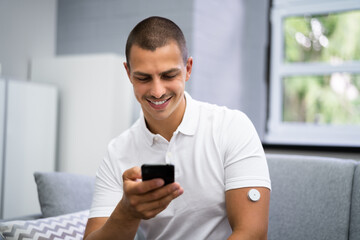 Man Using Continuous Glucose Remote Monitor