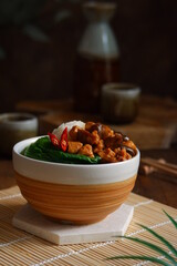 a bowl of rice with chicken meat and mushroom sauce 