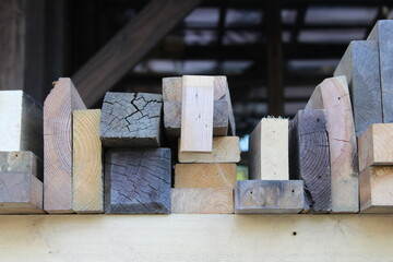 Planks of wood on carpenter's shelf