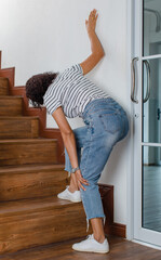 Woman cannot walk climb stair, she stops and use hand hold leg with feeling pain, suffers, hurt and...