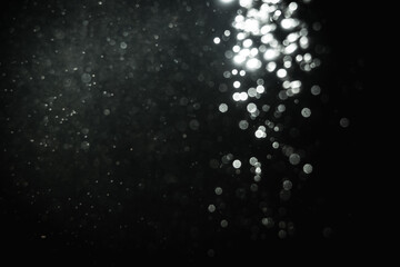 Glittering stars of blur white bokeh with black background