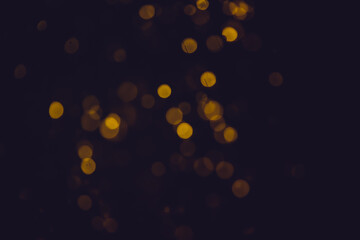 Abstract gold bokeh with black background