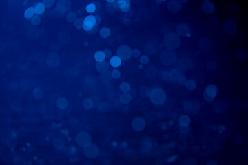 Fototapeta na wymiar Abstract blue bokeh with black background