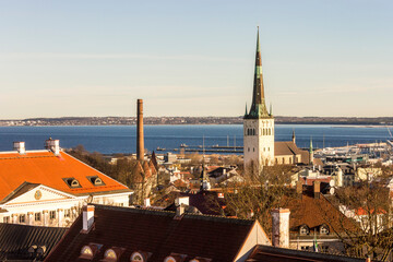 Tallinn, Estonia. Aerial view at sunset of the Old Town with the Church of St Olaf and the towers....