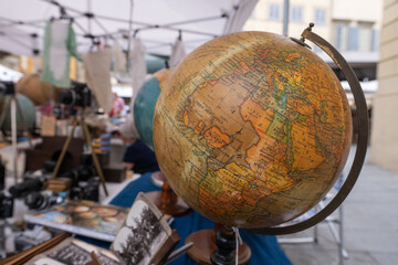 Old globe on stand of antiques market in Arezzo Italy