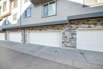 Three-storey townhouses exterior with attached garage on the first floor