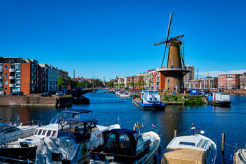 View of the harbour of Delfshaven and the old grain mill De Destilleerketel. Rotterdam, Netherlands
